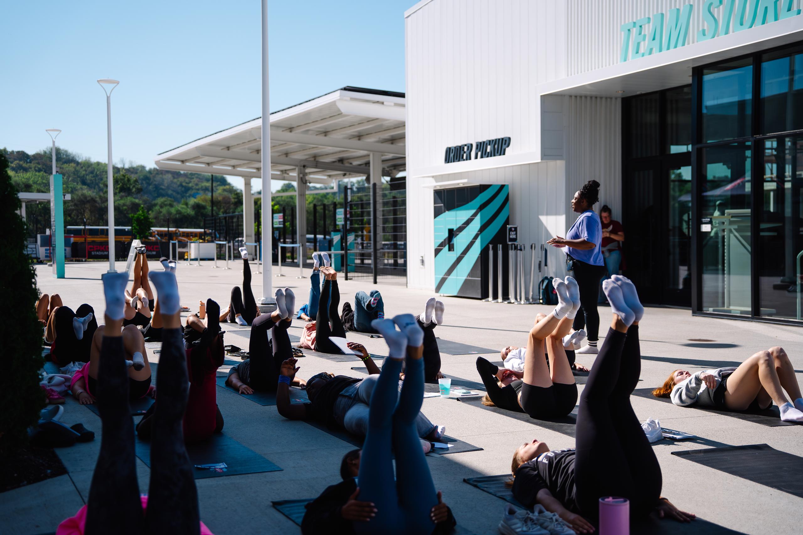 Sideline the Stigma attendees doing some mindful body work at CPKC Stadium.