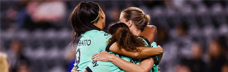 Bia, Ally and Michelle celebrating goal as match report cover photo.