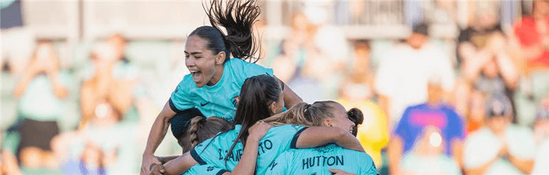 Lo'eau LaBonta jumps on top of teammates after a goal!