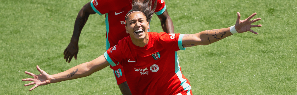 Match report cover image of Bia and Temwa celebrating a goal.